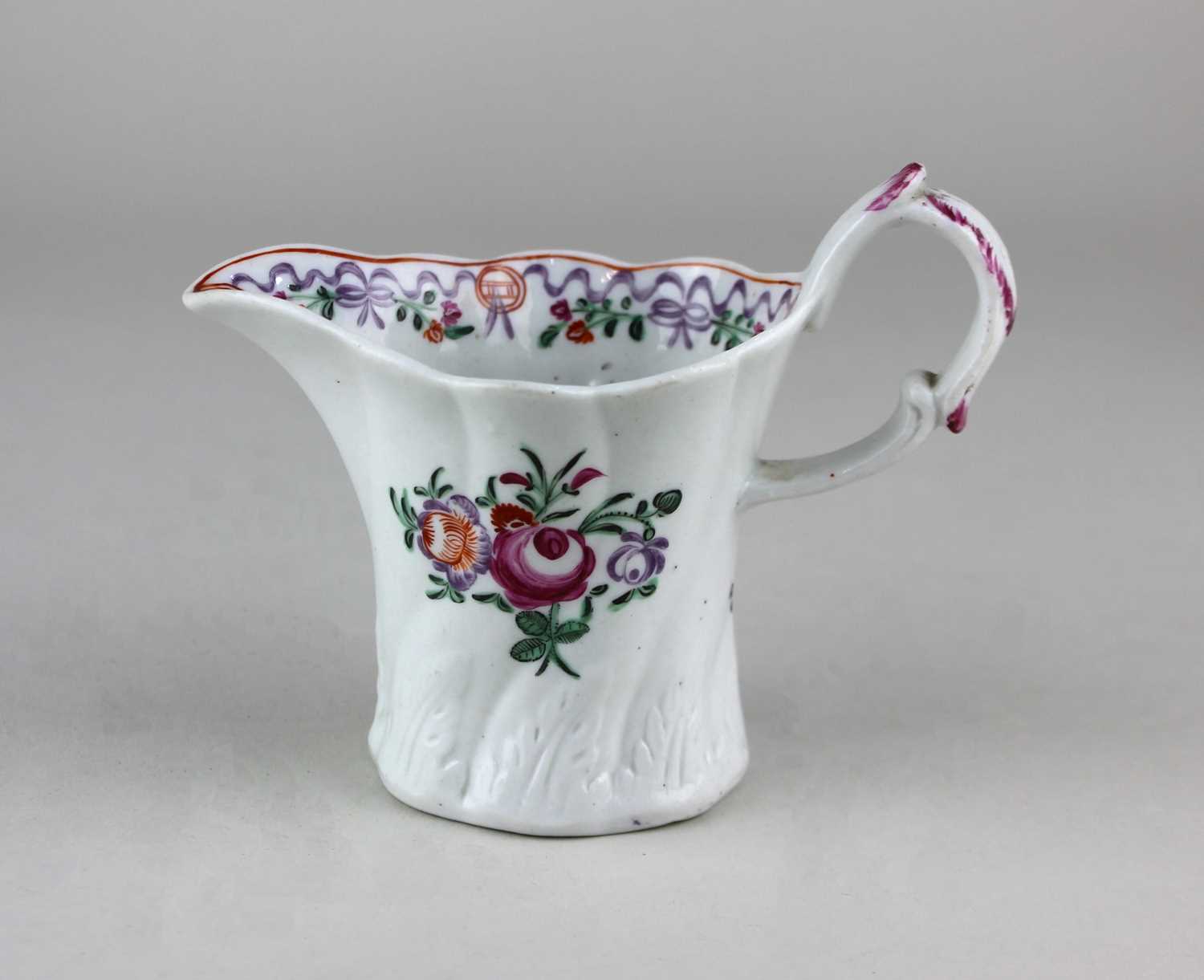 An 18th century English porcelain jug, c.1785/1790, possibly New hall, the flared wrythern fluted