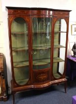 An Edwardian mahogany inlaid display cabinet with central dome glazed panel door flanked by two