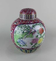 A Chinese ceramic pink ground ginger jar and cover decorated with panels of birds and flowers 29cm