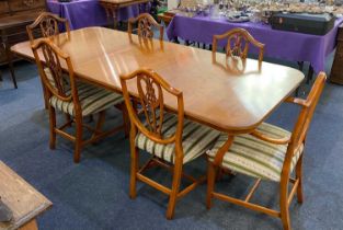 A yew wood extending dining table rectangular top with rounded corners and an extra leaf, twin