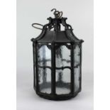 A bronzed hanging lantern in the Arts & Crafts style the octagonal form having ogee supports and