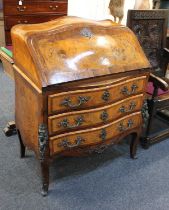 A Continental inlaid marquetry bureau bombe form decorated with a central cartouche flanked by