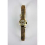 A Talis 9ct gold lady's bracelet wristwatch the signed circular silvered dial with gilt baton