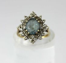 A 9ct gold synthetic pale blue and colourless oval cluster ring, claw set with the oval cut
