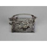 A Elizabeth II silver card holder in the design of a Chinese dragon, inscribed ‘Presented by the