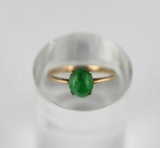 A gold ring claw set with an oval jade cabochon detailed indistinctly '9k', ring size I 1/2, gross