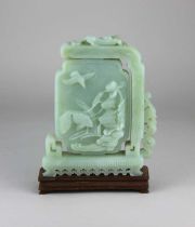 A Chinese jade plaque decorated with birds and fish 20.5cm high, on wooden stand