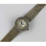 A Longines 18ct white gold and diamond lady's dress bracelet watch, the signed textured silvered