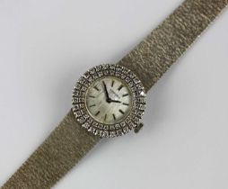 A Longines 18ct white gold and diamond lady's dress bracelet watch, the signed textured silvered