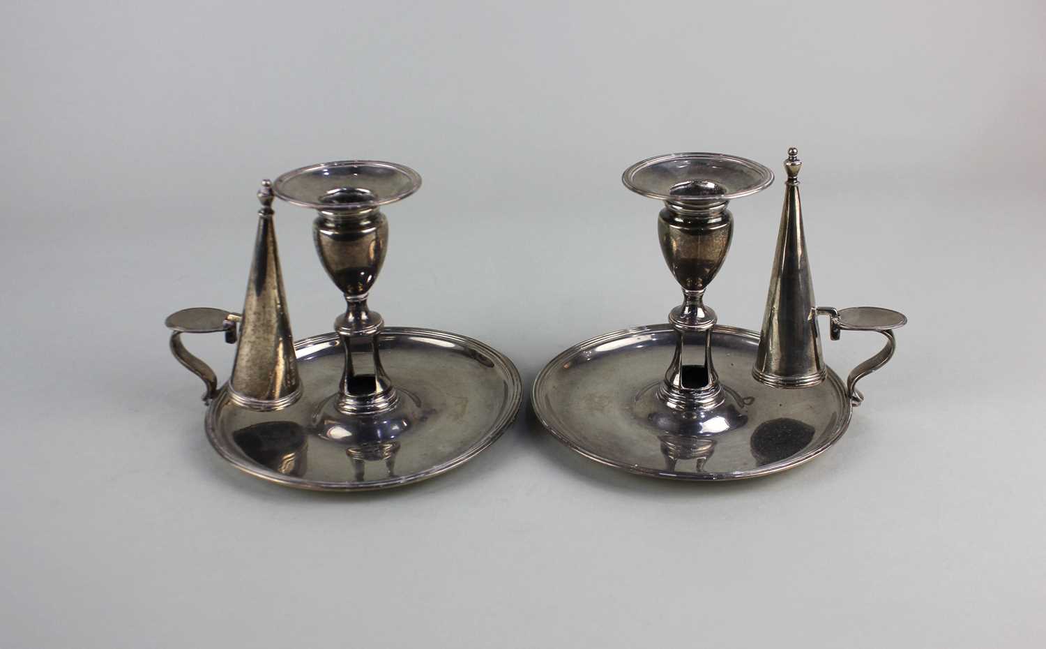 A pair of George III silver chambersticks with detachable sconces and snuffers on circular bases,