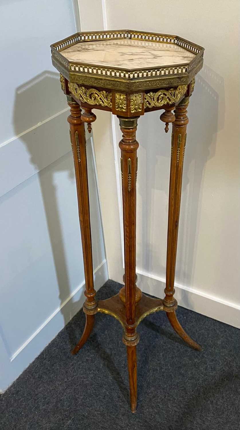 A French gilt metal mounted jardiniere stand, with octagonal marble top on turned and fluted legs