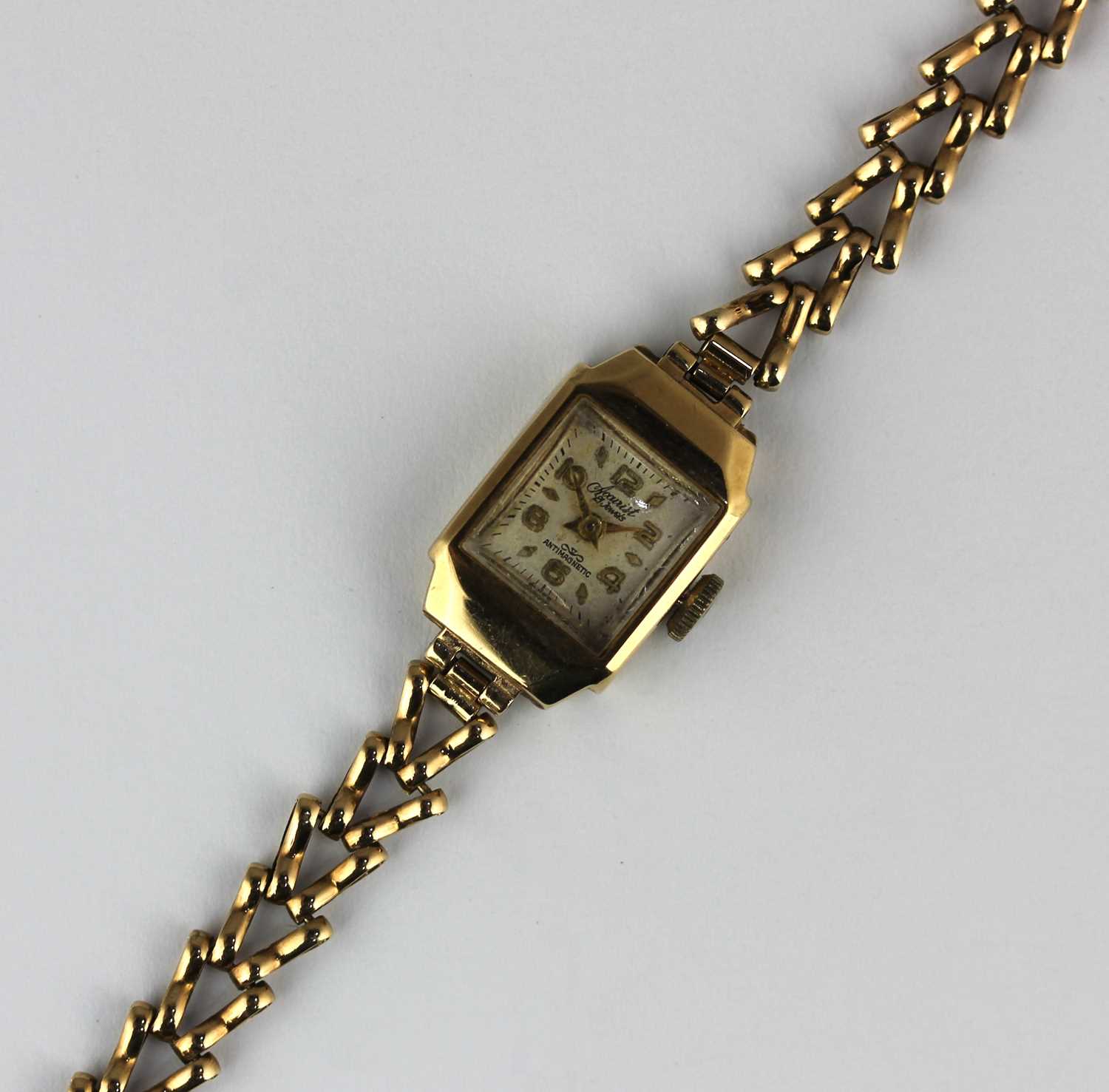 An Accurist 9ct gold shaped rectangular cased lady's bracelet wristwatch, the signed square silvered