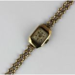 An Accurist 9ct gold shaped rectangular cased lady's bracelet wristwatch, the signed square silvered