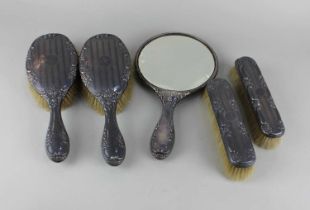 A George V silver five piece silver dressing table set comprising of two pairs of brushes and a hand
