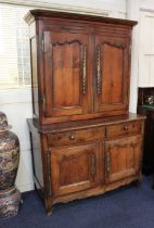 A French oak buffet deux corps / dresser, the top section with two carved panel doors enclosing