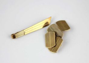 A pair of 9ct gold curved rectangular cufflinks with engine turned decoration, Birmingham 1947, with