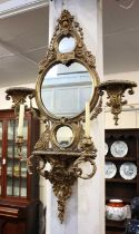 A giltwood and gesso two branch girandole wall mirror, with three circular mirror plates within a