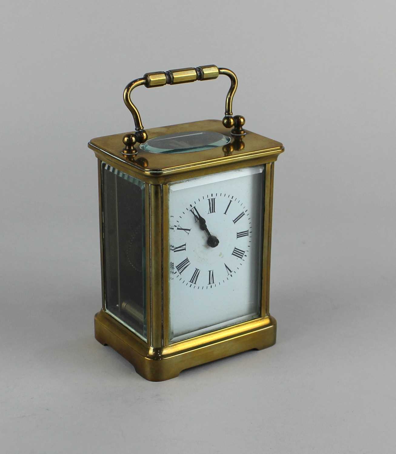 A brass carriage clock white enamel dial with Roman numerals, 14cm
