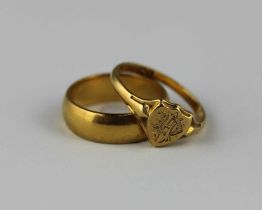 A 22ct gold band ring, 6.5g, and an 18ct gold signet ring, 2.7g (2)