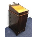 A small Victorian oak Davenport, with pierced gilt metal three quarter gallery above a leather inset