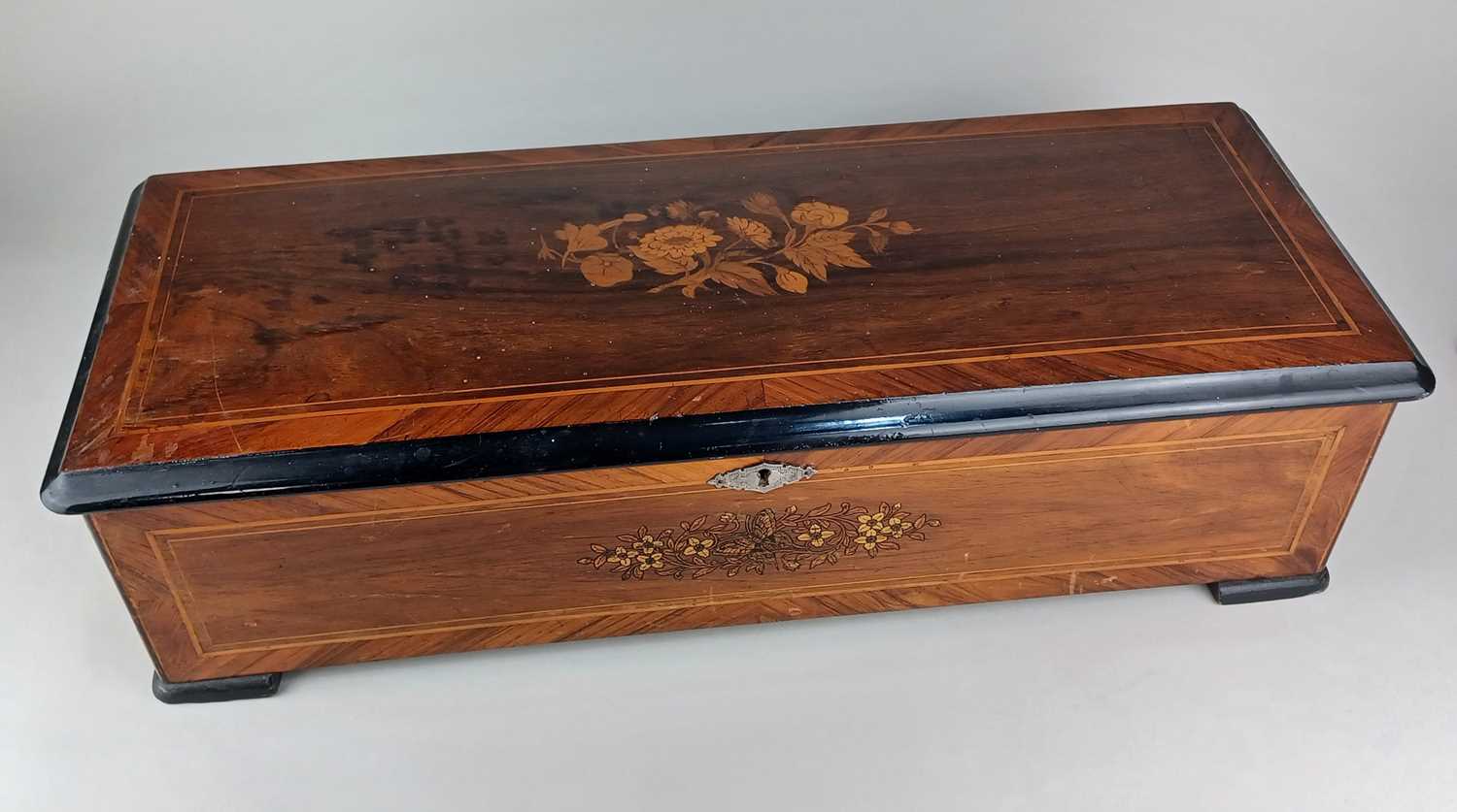 A 19th century Swiss rosewood and marquetry inlaid music box playing twelve airs 59cm