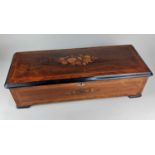 A 19th century Swiss rosewood and marquetry inlaid music box playing twelve airs 59cm