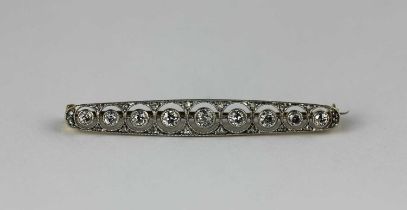 A yellow and white gold and diamond brooch, collet set with a row of nine principal circular cut
