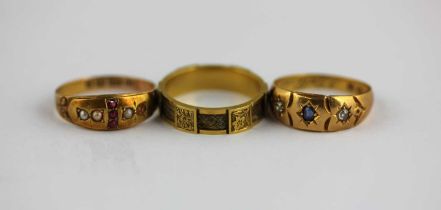 A Victorian band ring mounted with plaited hair and with alternating floral and scroll engraved