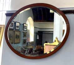 An Edwardian satinwood and mahogany framed oval wall mirror bevelled mirror plate 71cm by 57cm