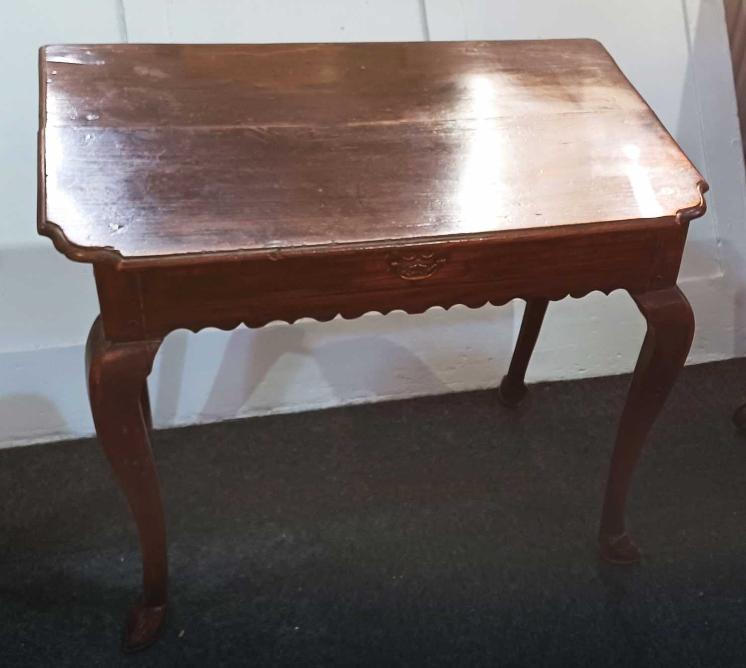 A George III oak side table with frieze drawer and wavy apron, on cabriole legs 74cm