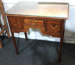 A George III oak kneehole side table rectangular top with moulded edge, three drawers with brass