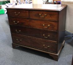 A George III mahogany chest of two short over three long drawers, with crossbanded top on bracket