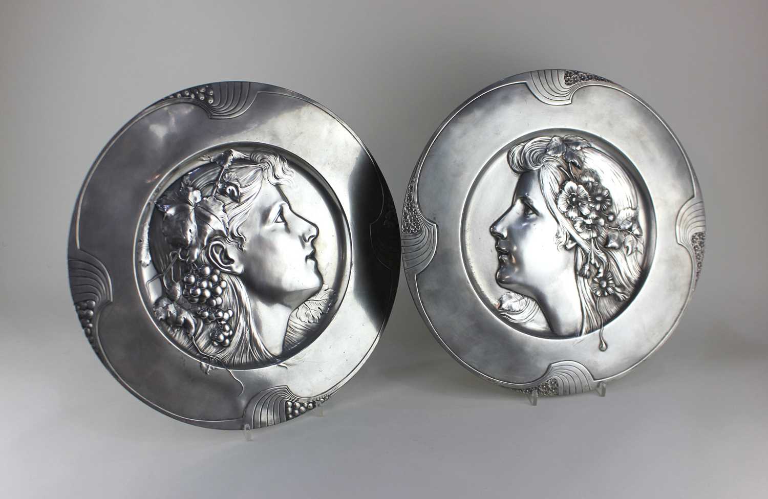 A pair of WMF Art Nouveau pewter plaques, numbered 294 & 294A, c.1900 / 1910, modelled in relief