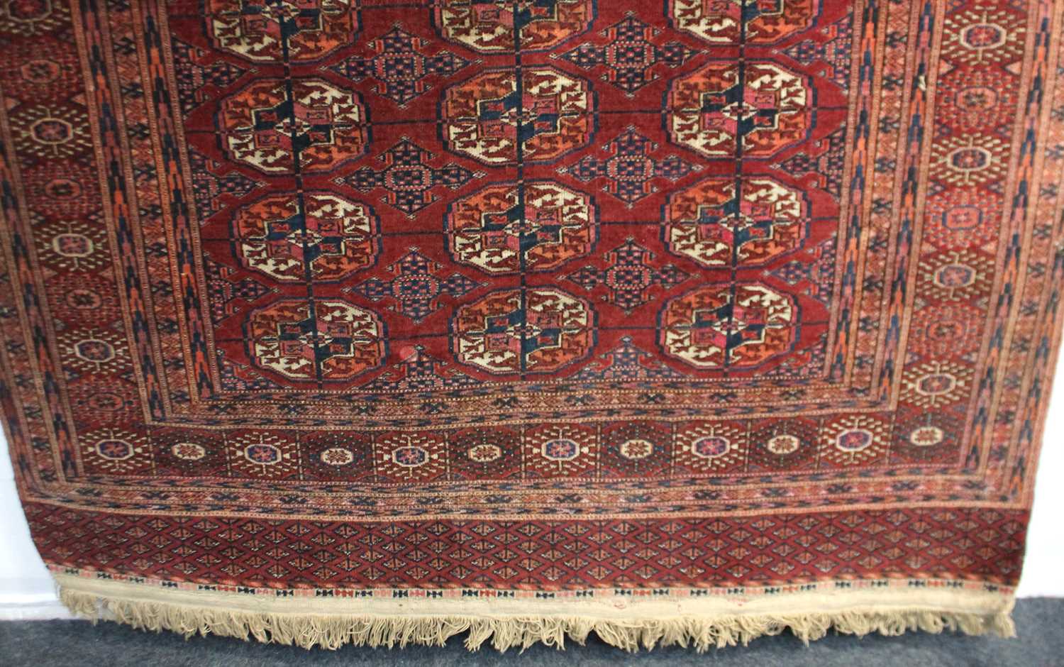A Bokhara Turkoman type rug, with three rows of guls on red ground, 170cm by 125cm