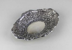 A George V silver dish with embossed floral decoration, maker Horace Woodward & Co Ltd, London 1893,