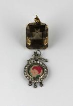A silver and colourless paste circular pendant locket having a bow surmount, together with a smoky