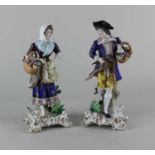 A pair of Samson porcelain figures of a gentleman and a lady carrying dead game and a basket of