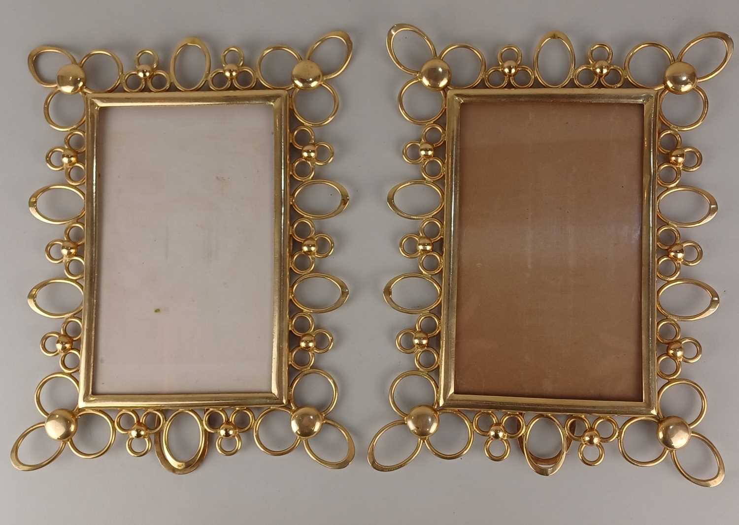 A pair of late 19th / early 20th century brass photo frames, being of rectangular form with openwork