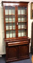 A Victorian mahogany glazed bookcase, with two glazed panel doors enclosing three adjustable
