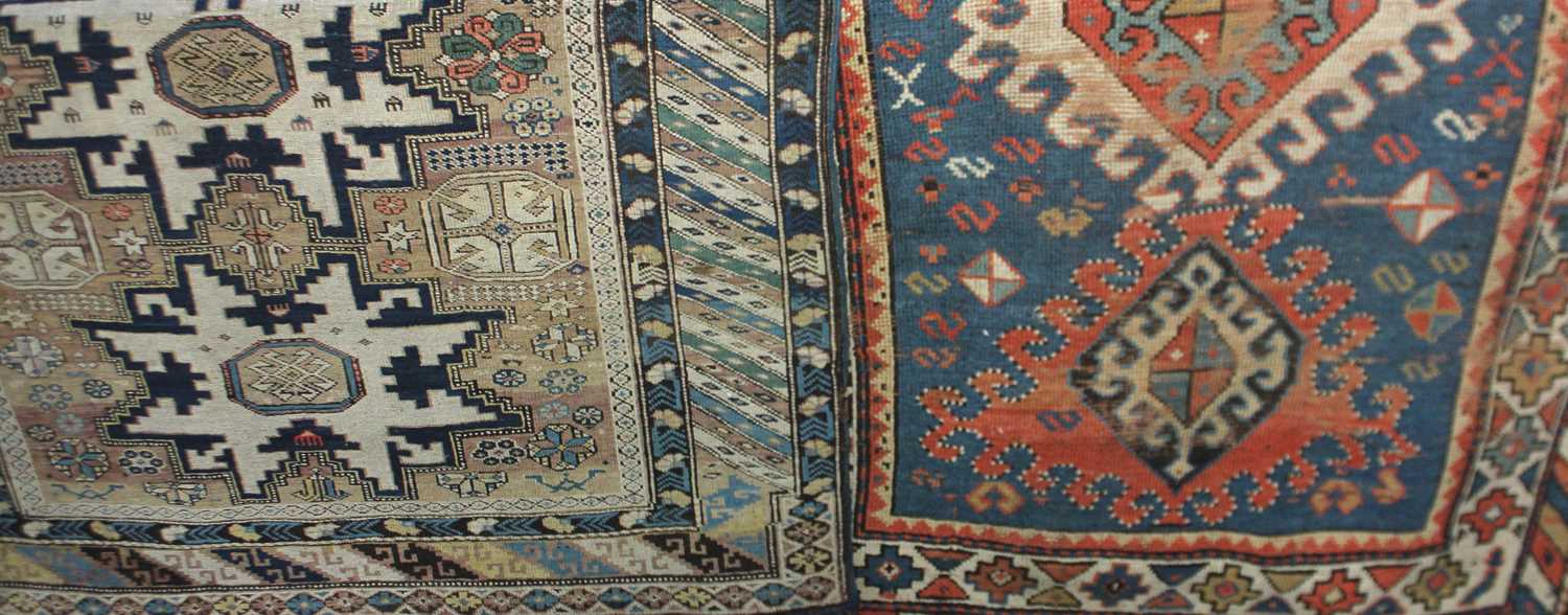 A Kazak type rug, buff coloured ground with star shaped medallion motifs within multiguard border,