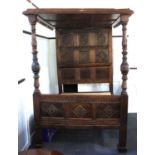 A carved oak four poster double bed with carved panel ceiling and pine slats approx 144cm wide,