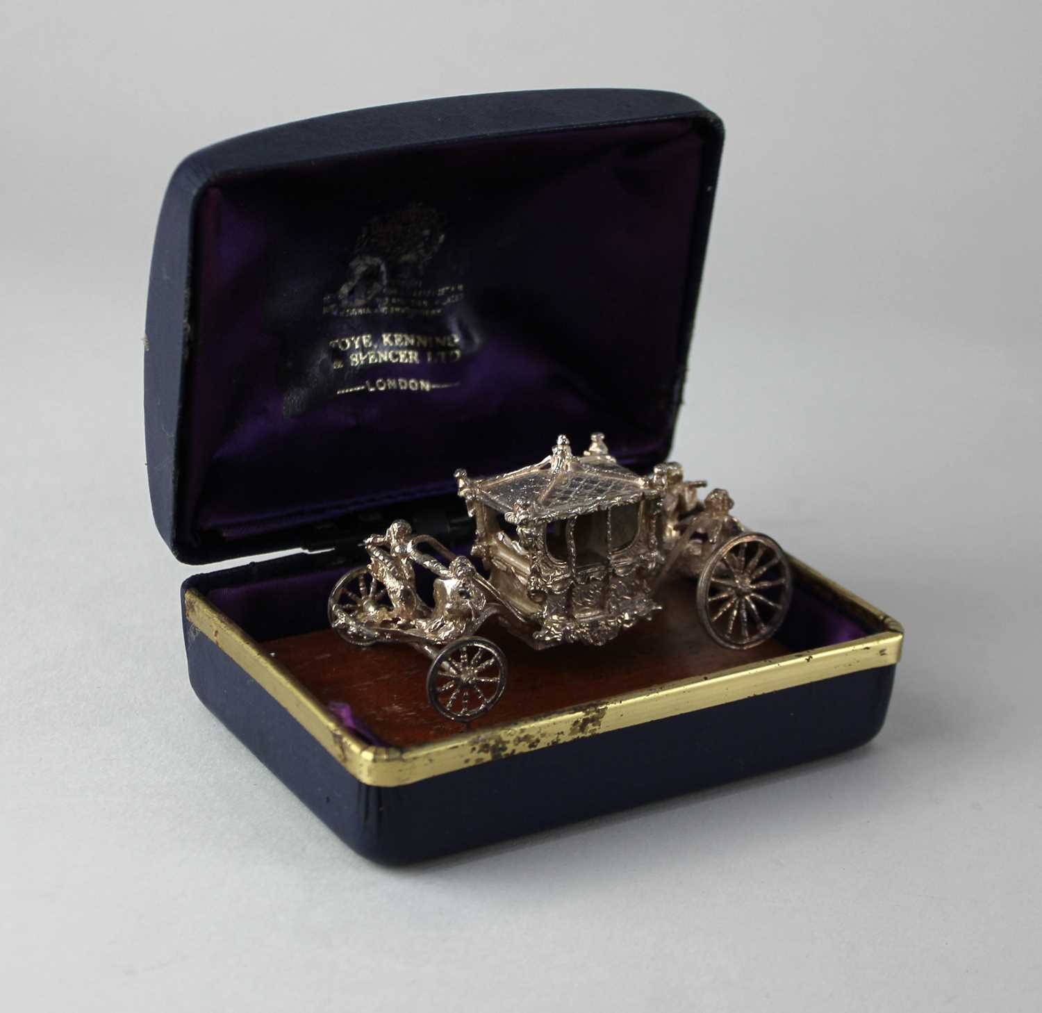 A Toye Kenning & Spencer Ltd. silver model of the Coronation Coach on wooden plinth in original