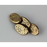 A pair of Victorian 9ct gold cufflinks, the oval backs and fronts with floral engraved decoration,