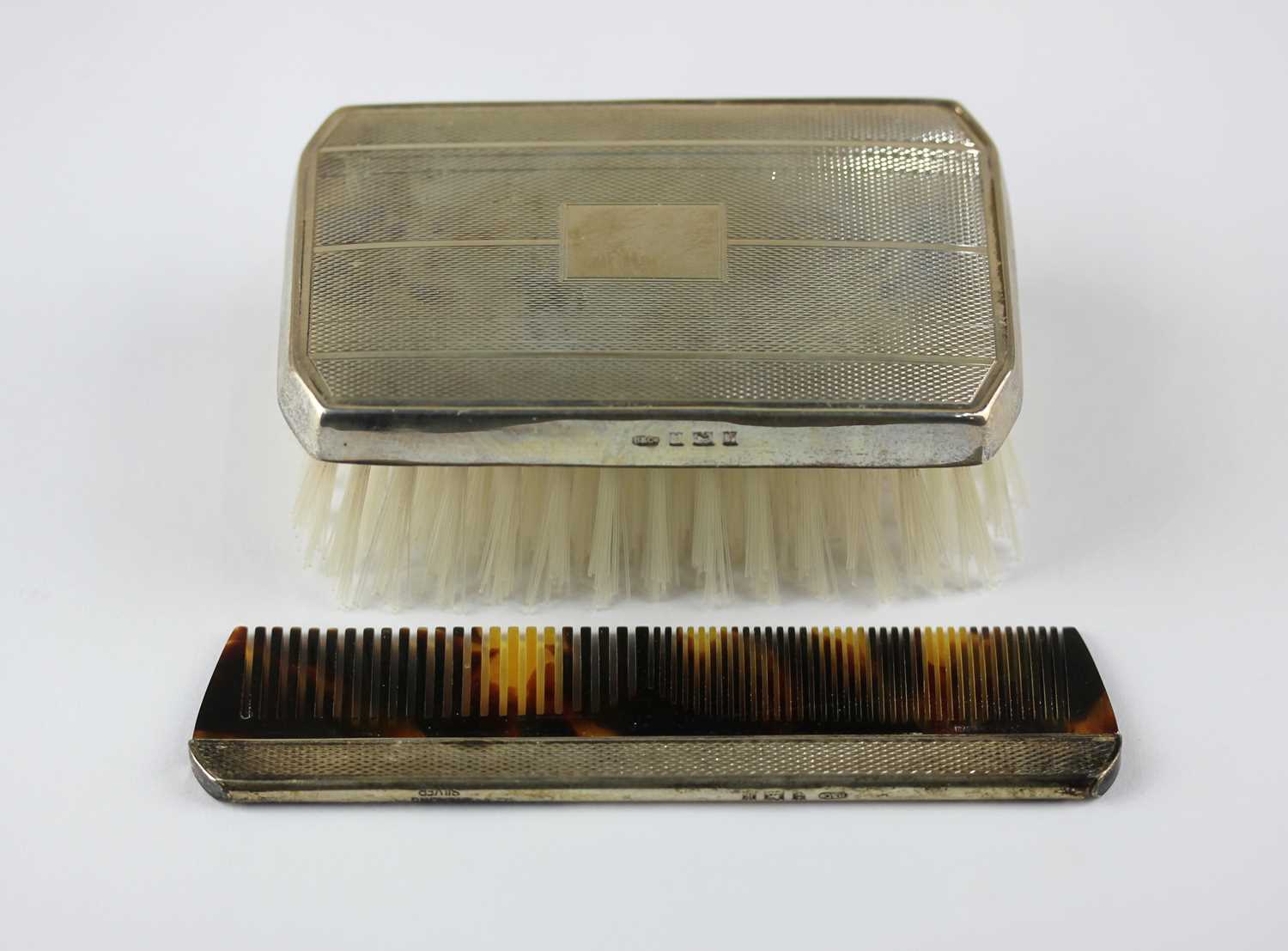 An Elizabeth II silver backed brush, maker B & Co, Birmingham 1970, and a silver backed comb