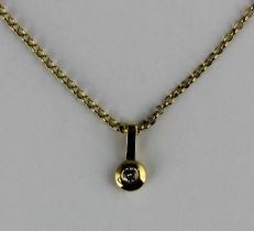 A gold and diamond single stone pendant mounted with a circular cut diamond detailed '18c', with a
