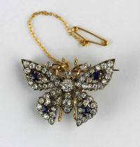 A gold backed and silver set diamond and sapphire brooch designed as a butterfly mounted with