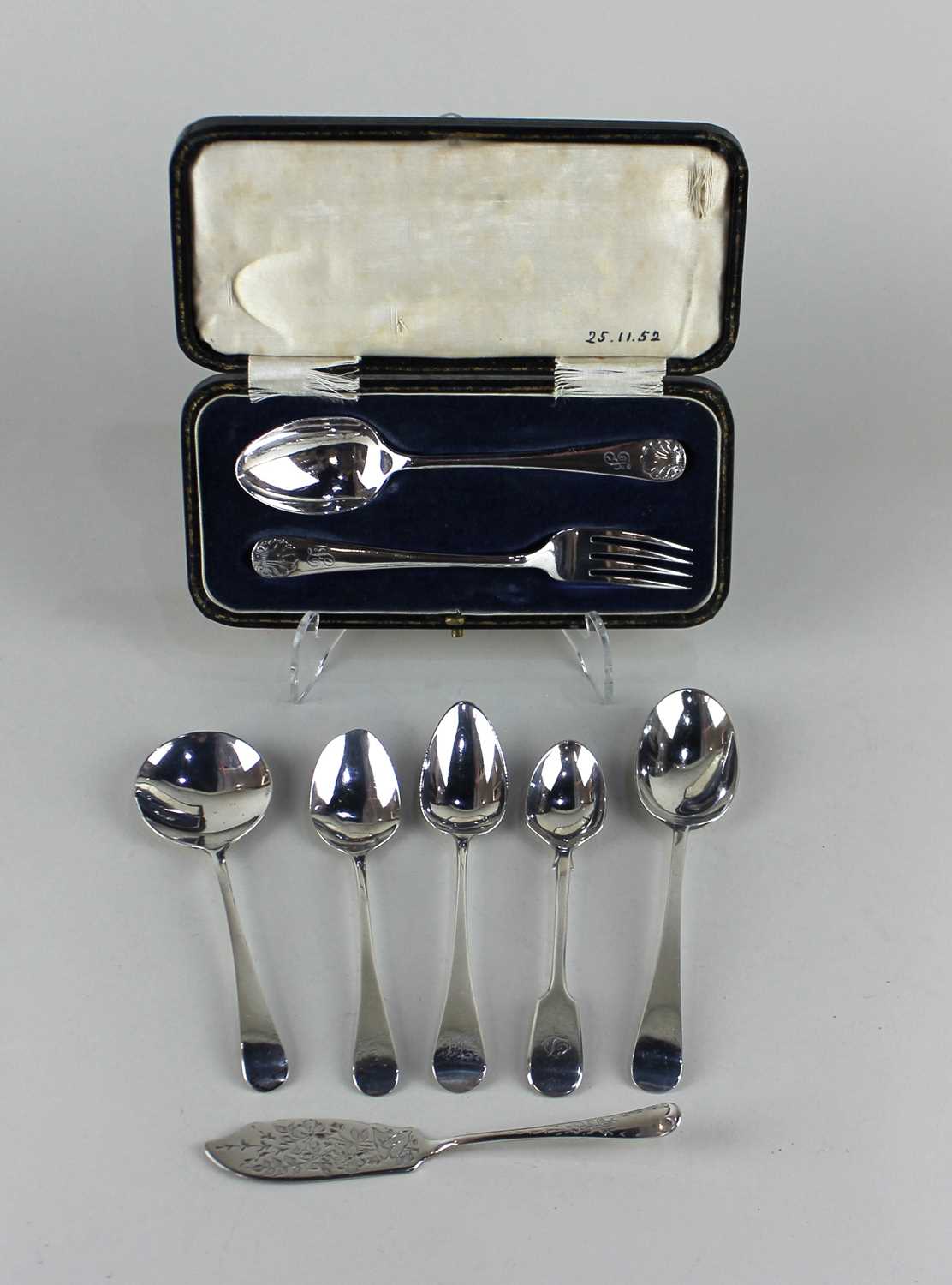 A cased George V silver christening spoon and fork set with engraved initials and shell terminals,