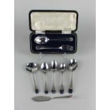 A cased George V silver christening spoon and fork set with engraved initials and shell terminals,