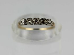 A gold and diamond five stone ring collet set with a row of graduated cushion shaped diamonds,