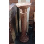 A rouge marble finished pedestal, of turned tapered cylindrical form, 107cm high.